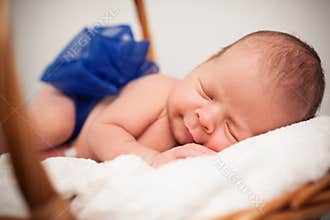 Cute baby with bow taking nap.
