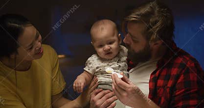 Father feeding a baby at night