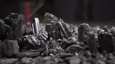 Mineral rocks black tourmaline obsidian stones with light, macro scene