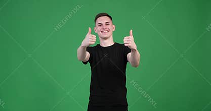 Man showing thumbs up in approval on green background