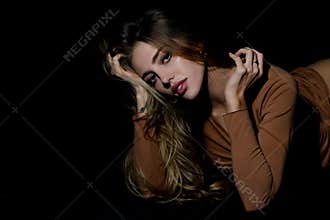 Sensual woman. Nice fit slim attractive tender sweet romantic girl lying on black bad. Portrait of a charming sexy