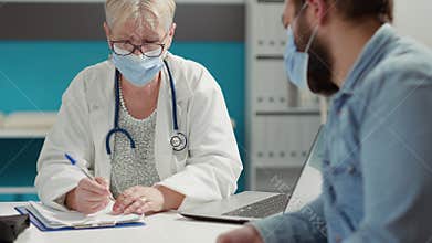Doctor and patient attending checkup consultation in office
