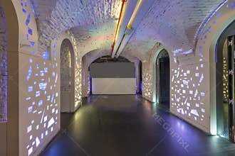 Empty room of a night club with led lights and white painted brick ceilings