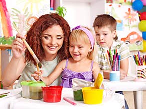 Child painting at easel.