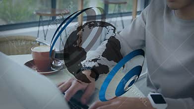 Animation of globe over biracial man using laptop