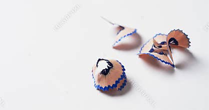 Close up of blue crayon shavings with copy space on white background, in slow motion