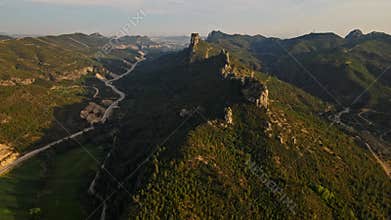 aerial scenic landscape with green fields, meadows, curved mountain river and mountain ridge with high mountains and