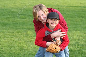 Mom Hugging Young Sports Son