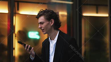 Angry and agressive man screams and talks on the phone, curses and quarrels in rage. Yelling at the interlocutor talking