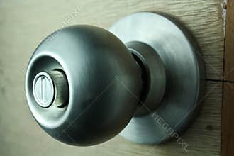 Door knob on unpainted Wooden Door