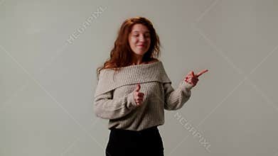 A young lady in pleasant amazement demonstrates admiration from unexpected surprise or gift. A girl model nods head