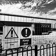 Construction Site Warning Signs Fixed To A Security Fence