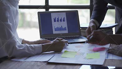 Business team meeting to analyze and discuss the financial report situation in