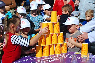 Children make a pyramid of glasses