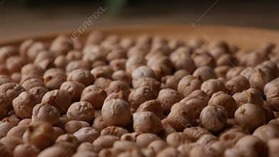 Raw Chickpeas on a rustic wooden table. Dry chickpea background close up. Chickpea legumes seed background.