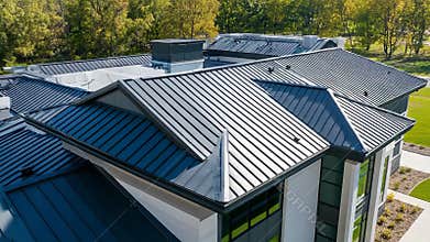 Modern metal roof covering residential building with complex architecture