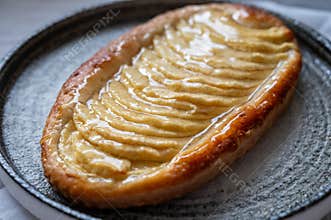 French fresh baked sweet puff pastry with fresh apple fruits in sirup in confectionery shop