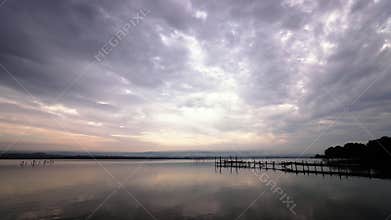 beautiful moving clouds at the seashore with a wooden pier