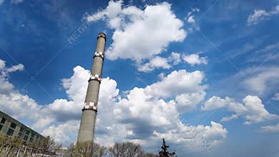brick industrial chimney against the moving sky. Industry concept image.
