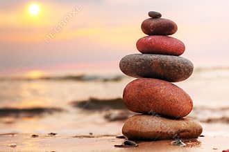 Stones pyramid on sand symbolizing harmony