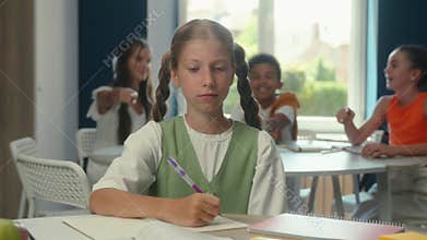 Caucasian teen schoolgirl sad upset kid student pupil studying at desk class school education stress problem cruel laugh