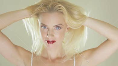 Pretty blonde woman playing with her hair
