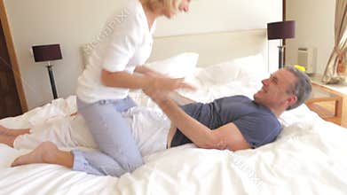 Senior wife sits on husband's