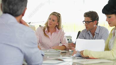 Team Meeting Around Table In Creative Office