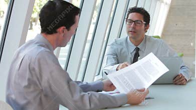 Two Businessmen With Laptop Having Meeting