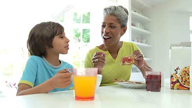 Grandmother And Grandson Having Breakfast Together