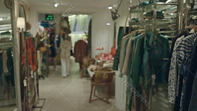 Woman shopping in stylish boutique with modern decor, featuring fashionable clothing and accessories in elegant indoor setting,