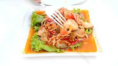 A person eating spicy mingle mushroom salad