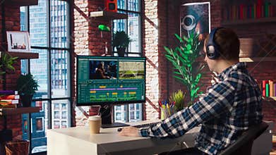 Videographer splicing film pieces on PC, editing them