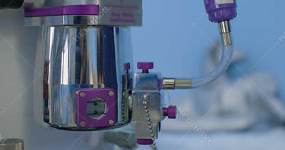 Filling the anesthesia gas machine. The anesthesiologist carefully connects the gas vaporizer to the anesthesia machine