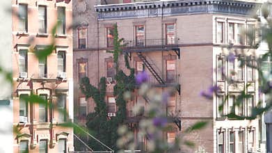 New York City building architecture, Manhattan. Residential house exterior. Red brick, fire escape.