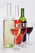 Bottles of red, white and rose wine with glasses