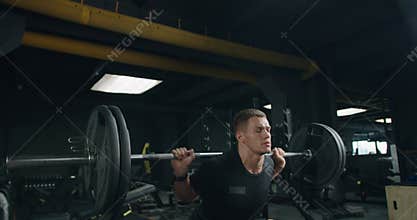 Focused Athlete Lifting Heavy Weights in a Modern Gym Setting