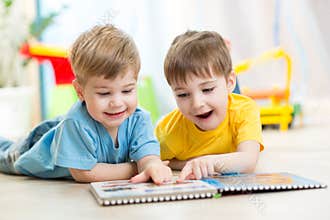 Happy kids friends reading together