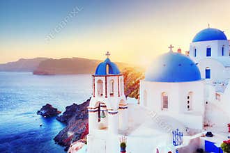 Oia town on Santorini Greece at sunset. Aegean sea