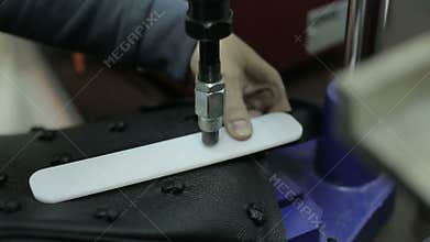 Production of handbags. The man is engaged in manufacturing women's handbags.
