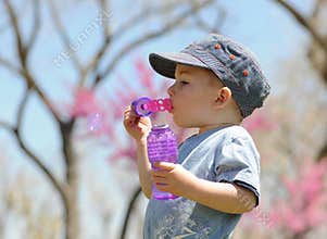 Child Blowing Soap Bubbles