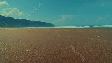 Scenic tropical beach with waves at sunset