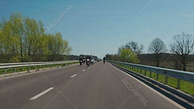 Steadicam tracking shot of a large motorcycle convoy on a highway