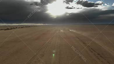Offroad vehicles cross Gobi Desert dunes in Mongolia through remote sand country, desert convoy, sand dunes, dune crossing