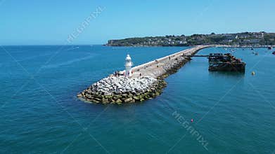 Brixham, Torbay, South Devon, England: DRONE VIEWS: Brixham Harbour lighthouse, the Outer Harbour Wall and various boats