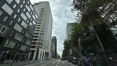 Low angle view of modern office and residential towers along city street