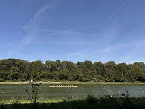 amsterdam zuida businessdistrict waterfront rowing team on calm lake beneath wide