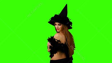 Halloween redheaded witch on green screen.