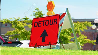 Orange detour road sign with straight arrow indicator