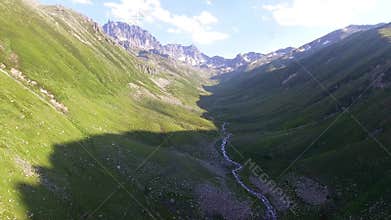 Aerial Kackar Mountains Turkey valley stream and green meadows open across treeless alpine terrain, water, rocks, creek, turkiye